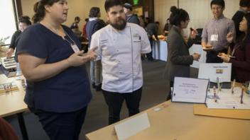 student conversing with attendee